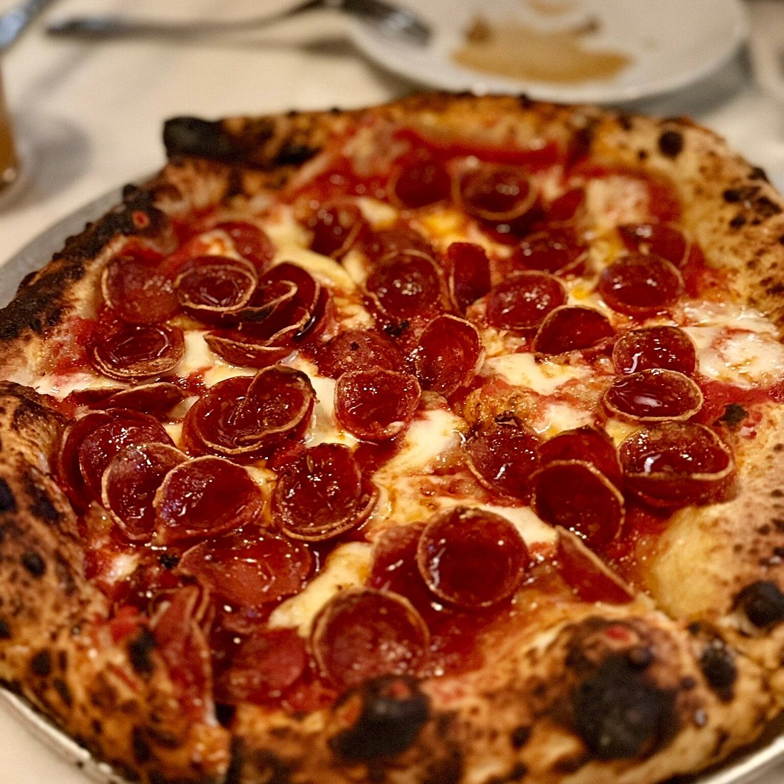 ViceVersa signature dishes Spicy Pepperoni Pizza, Wagyu Carpaccio, Oysters, Tuna Tartare, and Spicy Hot Honey Pizza